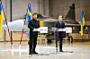 Ukrainas president Volodymyr Zelenskyj og Sveriges statsminister Ulf Kristersson under en pressekonferansen torsdag. I bakgrunnen står et moderne Gripen E-fly, den typen som Ukraina planlegger å kjøpe.