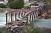 Tretten bru som går over Gudbrandsdalslågen i Gudbrandsdalen kollapset i elva og over E6 med en lastebil og en personbil på i august 2022. Flere lignende trebruer ble stengt etter hendelsen.