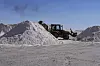 Bildet viser en arbeider som transporterer salt og som skal bearbeides på et litiumkarbonat-anlegg på saltsletten Uyuni i Bolivia.
