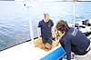 August Ekanger (t.v) og Jonas Hopsdal har brukt mye tid med programmering og montering av utstyr og sensorer om bord i Yara Birkeland-modellen. Sementsekker er brukt for å stabilisere fartøyet. Foto: Tore Stensvold