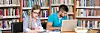In The Library - Handsome Two College Students With Laptop And Books Working In A High School - University Library - Shallow Depth Of Field