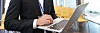 Concentrated businessman working with laptop in empty conference room