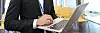 Concentrated businessman working with laptop in empty conference room