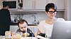 Woman working from home with child.