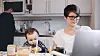 Woman working from home with child.