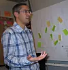 SLURV: Simon Brown mener at smidige metoder kan gi like mange it-fiaskoer som før hvis man slurver med håndverket. Veggen bak ham preges av de karakteristiske post it-lappene som brukes til å markere fremdrift i prosjektet.