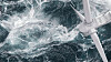 Aerial panorama of a close up wind turbine on the ocean