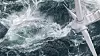 Aerial panorama of a close up wind turbine on the ocean