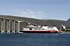 Hurtigruten Trollfjord under Tromsøbrua i sommer. Nå får selskapet nye eiere.