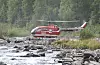 Bo 105 i hover over en elv sommerstid. Foto: Terje Heiestad