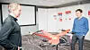 Harald Jøsendal fra Norsk Luftambulanse (t.v) og Terje Orskaug fra Avinor betrakter modellen av legedronen som en dag kan frakte helsepersonell til pasienter.