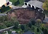 An aerial view of a large crater that appeared in the early hours in the central German town of Schmalkalden, November 1, 2010. A huge crater measuring 30 by 40 metres (98 by 131 feet ) has opened up in the middle of a residential estate early in the morning on Monday, according to local police. No one was reported hurt in the incident. REUTERS/Alex Domanski (GERMANY - Tags: DISASTER) Schmalkalden