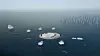 Den danske regjeringen hadde valgt en løsning med en mindre øy med flere flytende plattformer rundt. Denne legges nå bort.